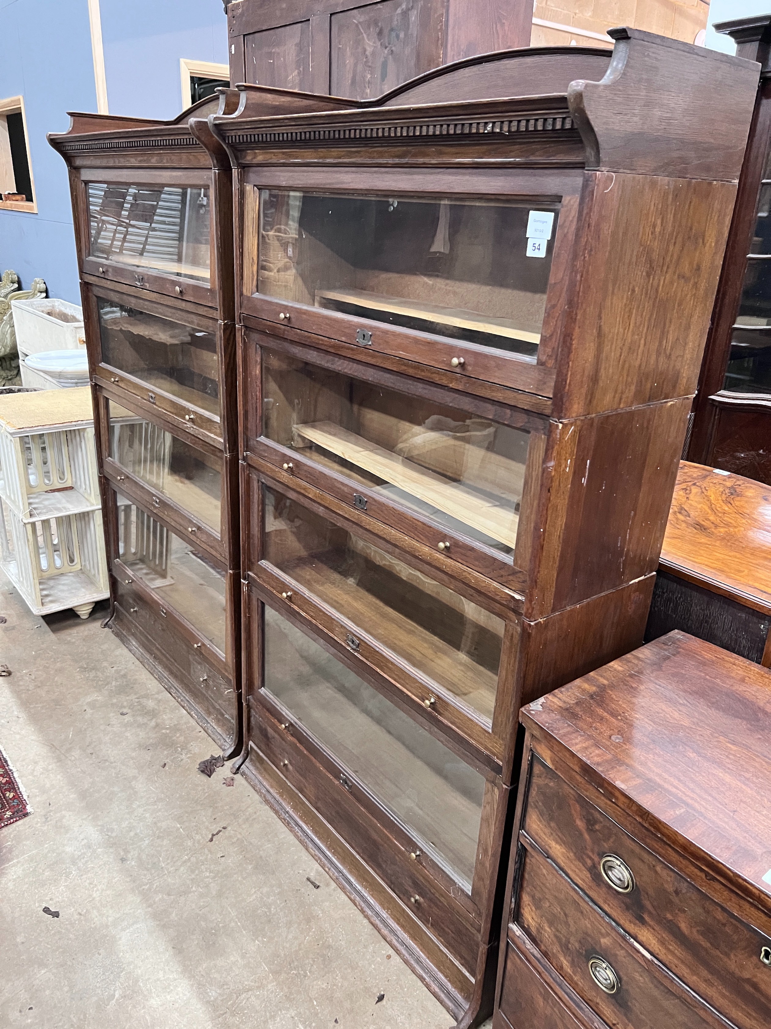A pair of Edwardian two tier oak Lebus four section bookcases, width 89cm, depth 36cm, height 166cm *Please note the sale commences at 9am.